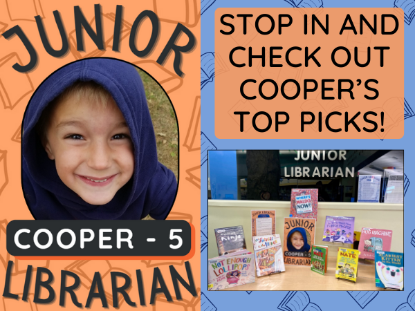 Photo of the library's Junior Librarian shown with his book display.